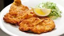 Wienerschnitzel aus Schweizer Kalbfleisch mit Preiselbeeren und Beilage